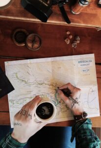 Man Having Coffee while Working on travel itinerary